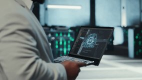 Server room system administrator using laptop to do infrastructure AI machine learning automatization. IT expert in high tech data center doing maintenance using artificial intelligence, camera B - Powered by Shutterstock - Get 15% off with code: PIKWIZARD15