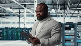 Engineer working in server farm using tablet to analyze data. IT professional examining infrastructure in data center using device, ensuring system integrity and security, camera B - Powered by Shutterstock - Get 15% off with code: PIKWIZARD15