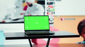 Green screen laptop in front of endless grid of streaming windows displaying mixed media. Mockup notebook and digital interface showing video platform distributing content to global viewers - Powered by Shutterstock - Get 15% off with code: PIKWIZARD15
