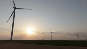 Farmer with digital tablet on agricultural field at sunset. Wind turbines in the background. Aerial view - Powered by Shutterstock - Get 15% off with code: PIKWIZARD15