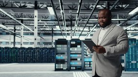 Cheerful data center programmer looking at code debugging tools running on tablet. Server farm IT professional typing on device touchscreen, writing script automating tasks, camera A - Powered by Shutterstock - Get 15% off with code: PIKWIZARD15