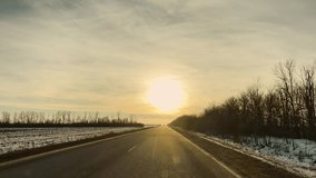 Dusk over the road, fading sunlight, warm winter hues, calm travel, natural beauty scene, long journey ahead, roadside snow, sunset colors, silhouette trees, serene evening. Quiet road sunset, winter - Powered by Shutterstock - Get 15% off with code: PIKWIZARD15