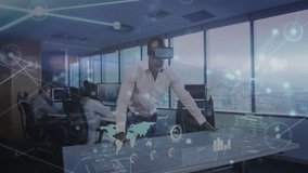 Man with VR headset tapping table and interacting with holographic charts to analyze business data. Technology, innovation, collaboration, data visualization, futurism, business intelligence, office - Powered by Shutterstock - Get 15% off with code: PIKWIZARD15