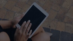 woman tapping tablet on bench in plaza for browsing content, with technology binary code cascading. Futuristic, digital, technology, mobile, urban, sleek, innovative - Powered by Shutterstock - Get 15% off with code: PIKWIZARD15