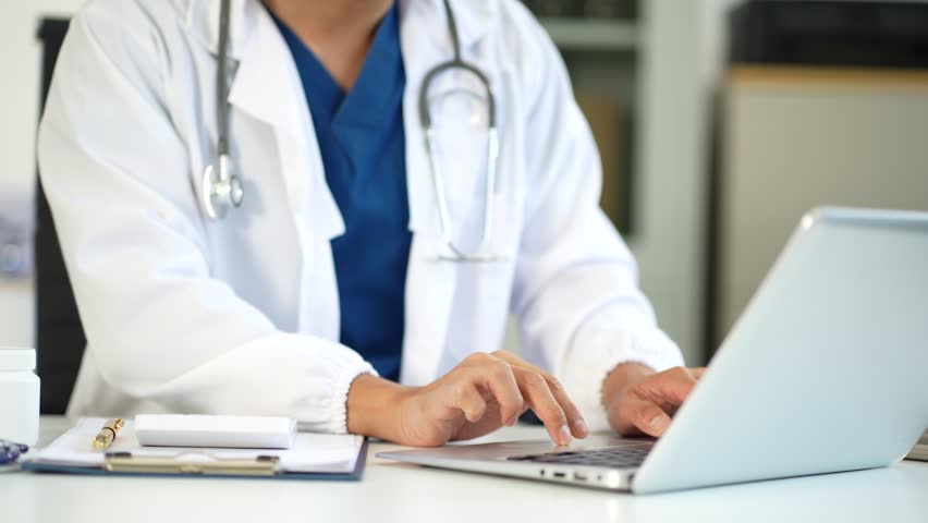 Doctor man use a service fee calculator to save money on health insurance, drug cost concept.