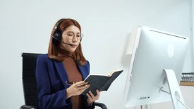 Friendly smiling female call-center agent with headset working on support hotline in office. - Powered by Shutterstock - Get 15% off with code: PIKWIZARD15