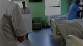 Ward team reacting to data overlays appearing by reviewing patient data and writing care notes. Medical, teamwork, healthcare, analysis, digital, clinical, professional - Powered by Shutterstock - Get 15% off with code: PIKWIZARD15