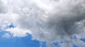 Time-lapse of soft cumulus clouds gently floating in bright blue sky, with crepuscular rays radiating through the cloud gaps. The light rays shift and dance across the sky. Natural weather background. - Powered by Shutterstock - Get 15% off with code: PIKWIZARD15