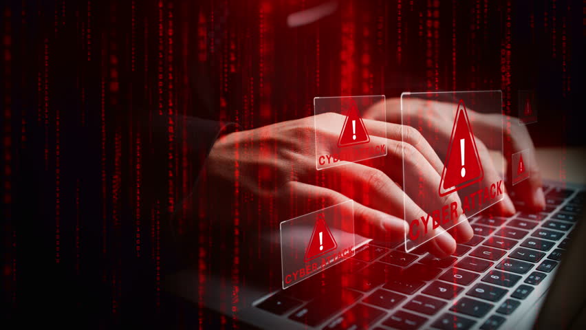 Laptop with hands typing amid glowing cyber attack alerts and red binary code, symbolizing hacking, data breach, and cybersecurity threats