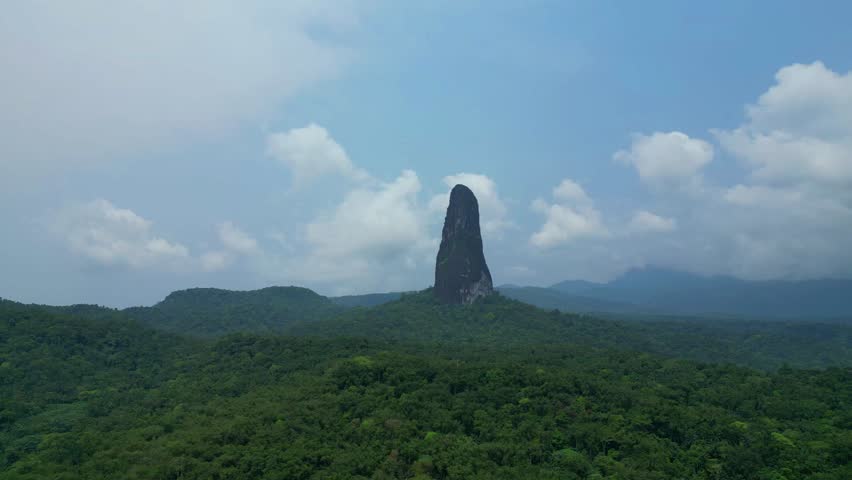 Flying over the magnificent green vegetation towards Pico Cao Grande, one of the icons of the São Tomé e Principe,Africa