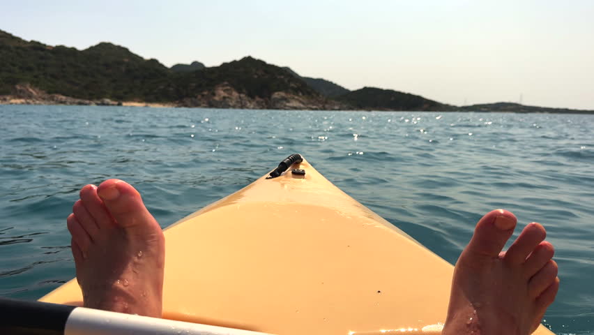 a man is on the sea in a yellow canoe