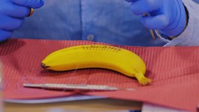 Medical trainees stitch banana surface in hands-on suturing skills session - Powered by Shutterstock - Get 15% off with code: PIKWIZARD15