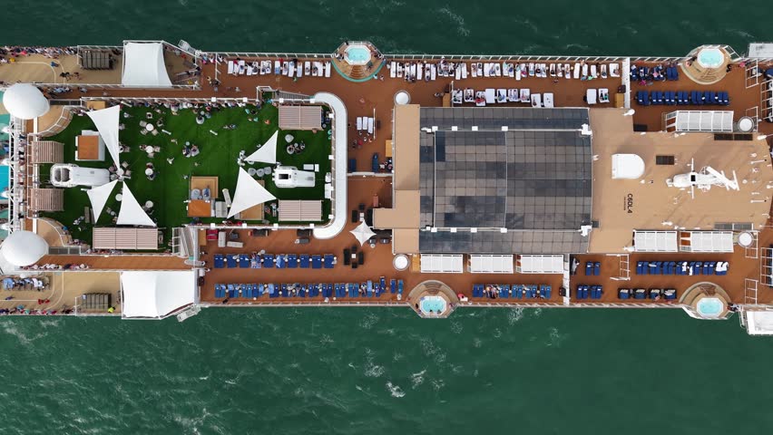 Aerial view of luxury liner voyage. Ship leaving port. Miami tour. Cruise ship voyage. Aerial top view of cruise in summer vacation. Cruise ship tour and travel at sea. Vacation cruise start