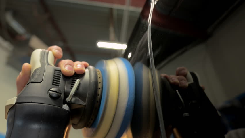 Man worker polishing the car body in a auto body shop. Slow motion - Powered by Shutterstock - Get 15% off with code: PIKWIZARD15