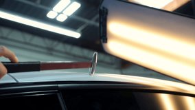Process of pointless dent repair on car body, mechanic at the auto shop with tools to repair dents in car body. PDR. Close up - Powered by Shutterstock - Get 15% off with code: PIKWIZARD15