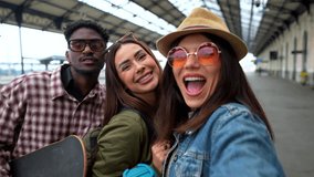 Diverse group of young friends capturing moment of excitement while waiting on train station platform, sharing anticipation for upcoming journey - Powered by Shutterstock - Get 15% off with code: PIKWIZARD15