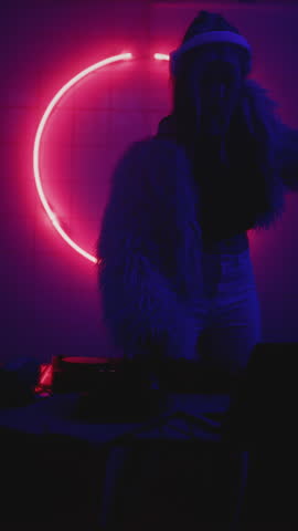 Woman DJ dancing in night neon party. Female disk jockey playing music. Artist make modern sound