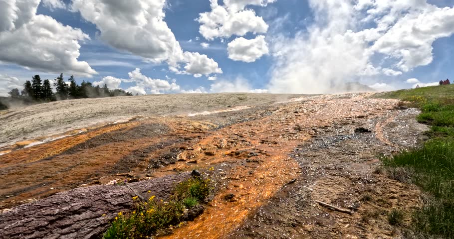 Yellowstone National Park (Travel And Tourism). Run-Off Streaming Down The Hillside Into Firehole River From An Active Hot Spring Geyser Pool Above.