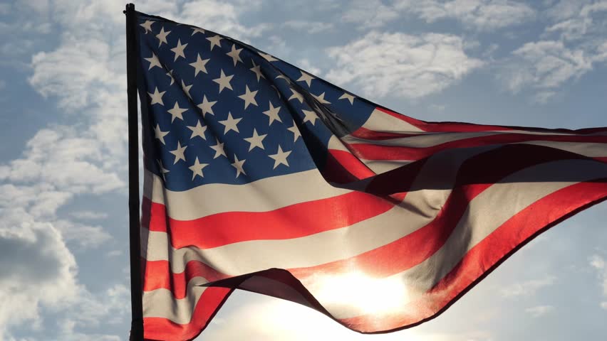 close up American flag waving in the wind against sunset with slow motion. outdoor background for 4th of July, Memorial Day, Independence Day, Veterans Day, Celebrate USA, American President Election