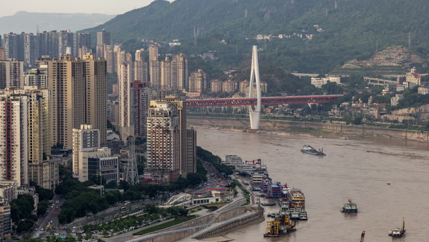 CHONGQING, CHINA - 28 MAY 2025 : Timelapse of the amazing Chongqing cyberpunk city skyline from a high vantage point with the yangtze river