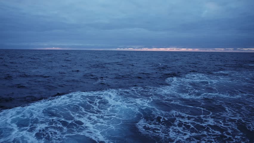 Sea View from Ship at Sunset with Dramatic Sky and Clouds, Horizon and Sea Water and Night with Storm Clouds in Vast Endless Open Ocean Sea View from Boat or Ship, Background with Copy Space