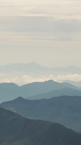 Misty Layers of Mountains Background with Copy Space for Text, Mist in Mountains Scenery at Sunset Vertical Video for Social Media Instagram Reels and Tiktok, Elevated View from Above