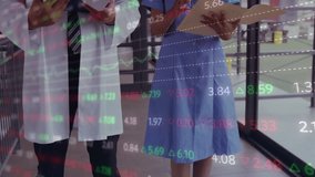 Doctor pointing clipboard and nurse turning pages while medical financial graphs overlay updating. Medical, analytics, professional, healthcare, technology, workplace, focus - Powered by Shutterstock - Get 15% off with code: PIKWIZARD15