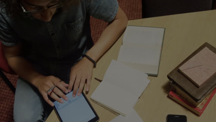 Man tapping blue tablet and referencing notebook while reviewing code overlay for tech development. Technology, coding, developer, workspace, innovation, education, digital - Powered by Shutterstock - Get 15% off with code: PIKWIZARD15