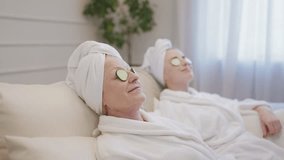 Senior lady and daughter putting cucumber slices on eyes, enjoying spa procedure - Powered by Shutterstock - Get 15% off with code: PIKWIZARD15