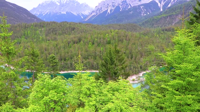Panoramic view of Germanys largest mountain Zugspitze alpine landscape with turquoise Blindsee lake forest rocks hills and mountains in the Alps Biberwier Reutte Tyrol Austria.