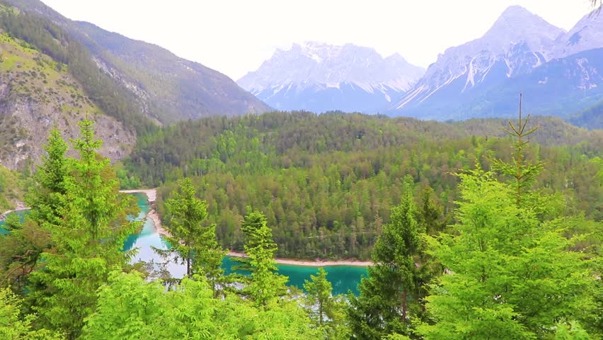Panoramic view of Germanys largest mountain Zugspitze alpine landscape with turquoise Blindsee lake forest rocks hills and mountains in the Alps Biberwier Reutte Tyrol Austria.