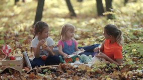 Enjoy a wonderfully colorful autumn picnic as children bond over tasty snacks in a beautiful forest setting - Powered by Shutterstock - Get 15% off with code: PIKWIZARD15