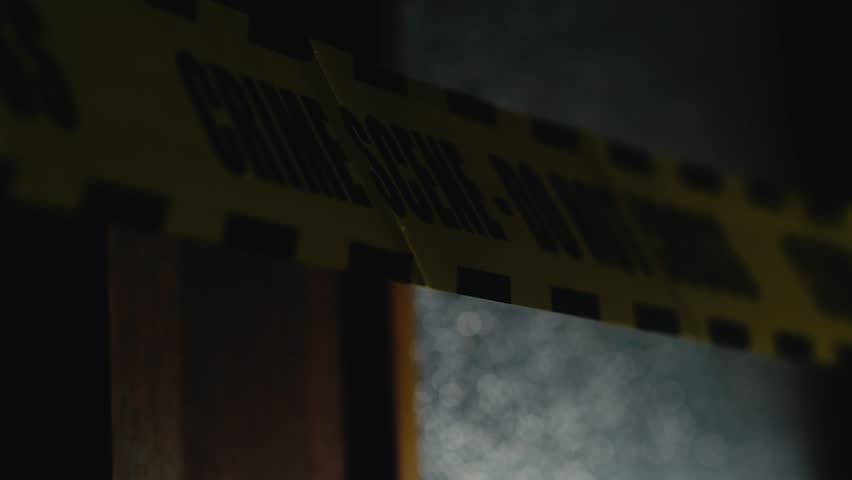 Light illuminates Police Crime scene reflective tape in dark setting