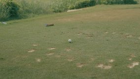 A male golfer's feet slowly approaches a teed-up ball on a divot-filled tee box, carrying an iron. Captured in slow motion, this clip highlights course conditions and golfer focus before the shot. - Powered by Shutterstock - Get 15% off with code: PIKWIZARD15