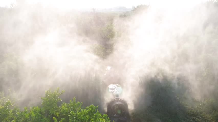 Tractor spraying pesticide drone aerial view, pesticides or insecticide spray on lettuce or iceberg field. Pesticides and insecticides on agricultural field in Spain