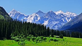 Aerial shot of majestic snow mountain range and green valley natural landscape in Xinjiang, China. - Powered by Shutterstock - Get 15% off with code: PIKWIZARD15