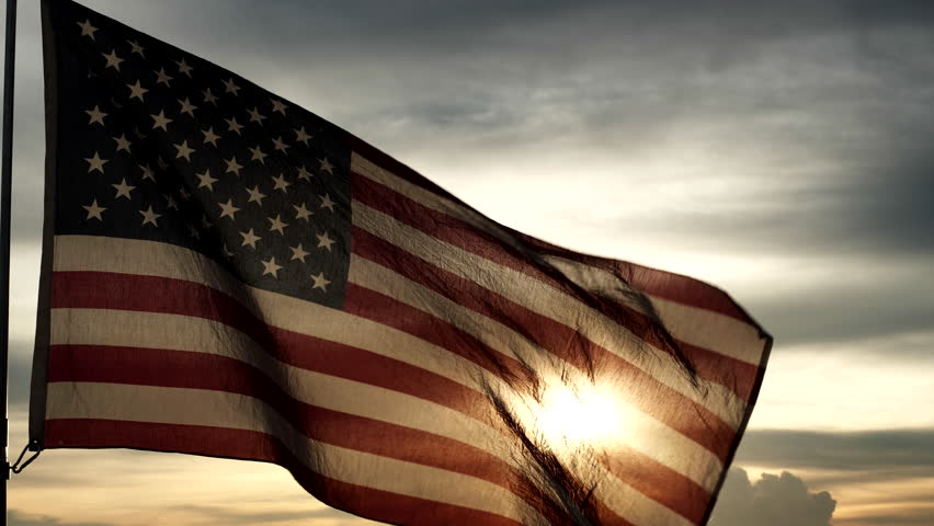 Happy 4th of July, Independence Day, Veterans Day, the Fourth of July, holidays, celebrations. USA American flag waving in the sky against backdrop of sunset, sunrise. Freedom, Celebration concepts