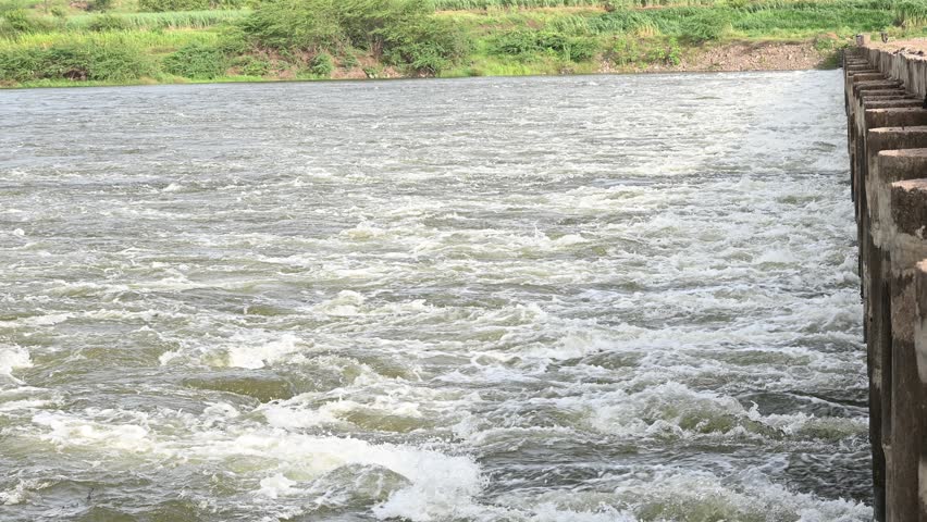 Fast flowing water from the river. Fast flowing water over rocks creating white water rapids