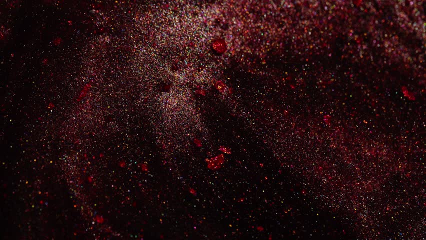 Video of deep red metallic texture flowing smoothly with sparkling highlights and rich color.