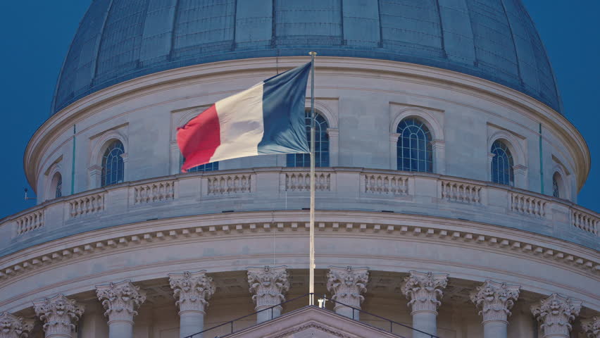 Pantheon building with french flag at dusk, Paris. France