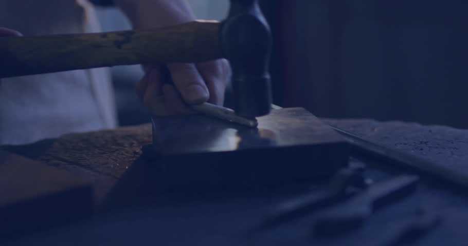 Female metalworker placing rod and hammering on anvil with social media icons boosting engagement. Craftsman, workshop, industrial, forging, craftsmanship, artisan, metalwork