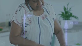 Food tech showing woman grabbing knife and chopping veggies with data overlays fluctuating. Cooking, kitchen, technology, health, precision, modern, lifestyle - Powered by Shutterstock - Get 15% off with code: PIKWIZARD15
