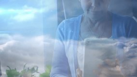 Senior woman raising tablet and tapping screen by window building cloud computing user icon network. Technology, connectivity, digital, innovation, senior, smart, cloud - Powered by Shutterstock - Get 15% off with code: PIKWIZARD15