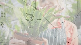 On tilting pot plant expert scanning cactus buds with tech data nodes overlay highlighting growth. Botanical, horticulture, technology, innovation, growth, visualization, exploration - Powered by Shutterstock - Get 15% off with code: PIKWIZARD15