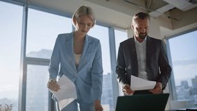 Partners looking work documents discussing deal terms at sunny cityscape cabinet. Smiling investors discussing contract handshaking at agency cabinet. Happy company colleagues concluding agreement - Powered by Shutterstock - Get 15% off with code: PIKWIZARD15