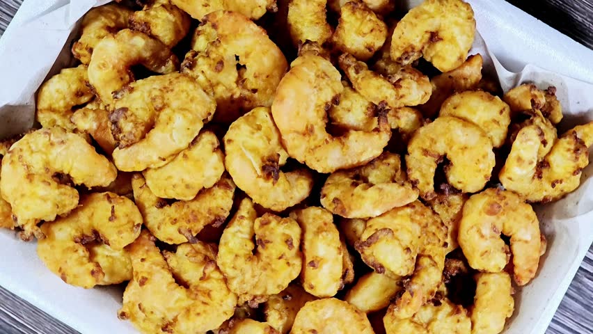 Fried shrimps covered with flour and fried in deep hot oil, shrimps are crustacean (a form of shellfish) with an elongated body and a primarily swimming mode of locomotion, Caridea or Dendrobranchiata