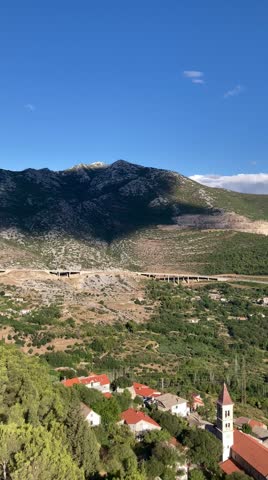 View from the top of the mountain by the Adriatic sea on the forest and a narrow road for cars at sunset on vacation in Croatia near the city of Split