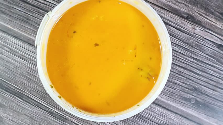 assorted seafood creamy soup of shrimps, squid, crabs, fish fillet, herbs, dill, garlic and onion, seafood mixture hot soup, healthy food concept of pieces of various sea food, selective focus