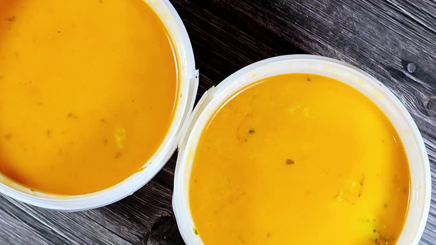 assorted seafood creamy soup of shrimps, squid, crabs, fish fillet, herbs, dill, garlic and onion, seafood mixture hot soup, healthy food concept of pieces of various sea food, selective focus