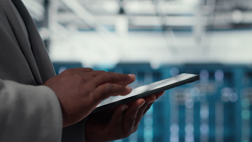 Close up of admin in data center workplace using tablet to calibrate energy usage. Server room IT specialist using device to inspect UPS configurations, doing maintenance on equipment - Powered by Shutterstock - Get 15% off with code: PIKWIZARD15